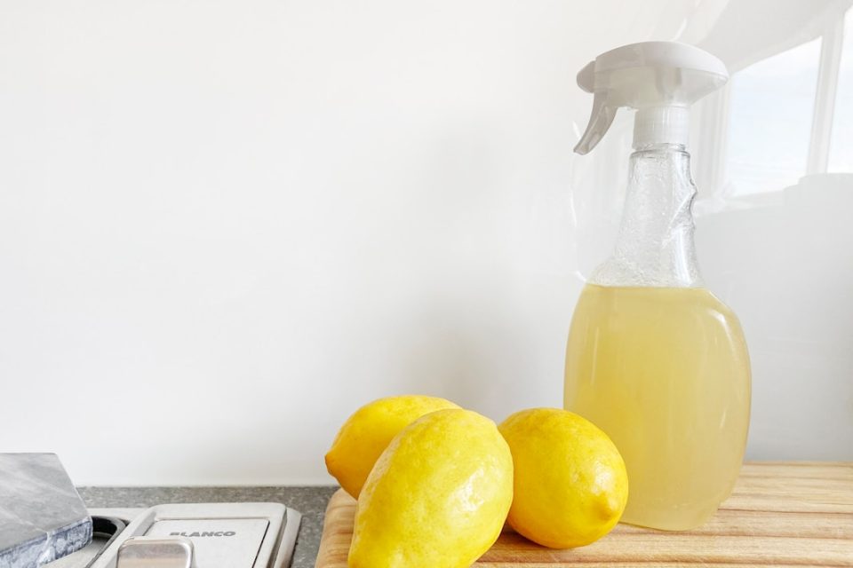 yellow lemon fruit beside clear glass bottle
